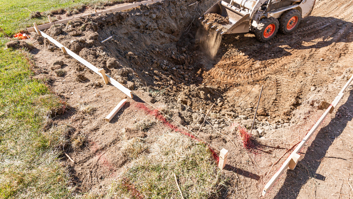 A truck is digging a hole in the ground